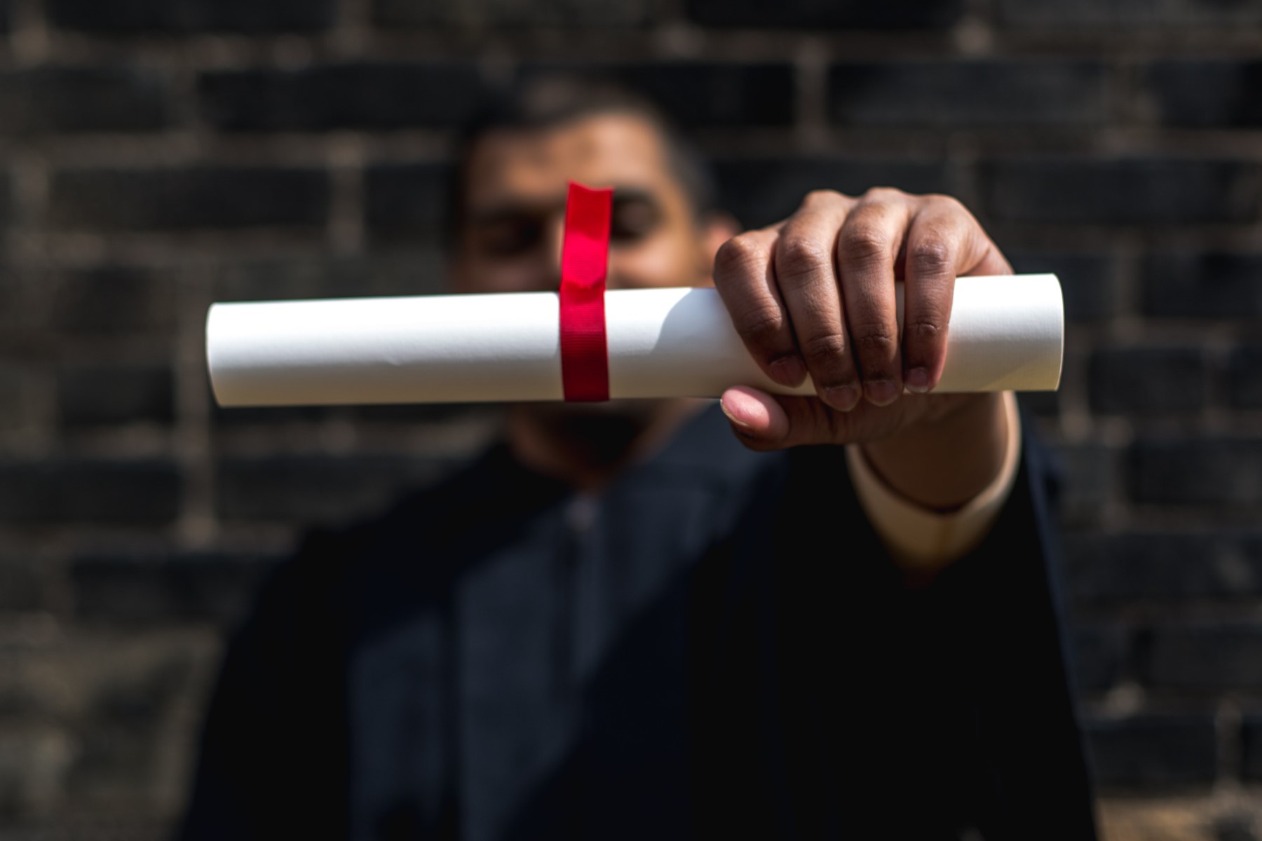 A graduate holds a diploma