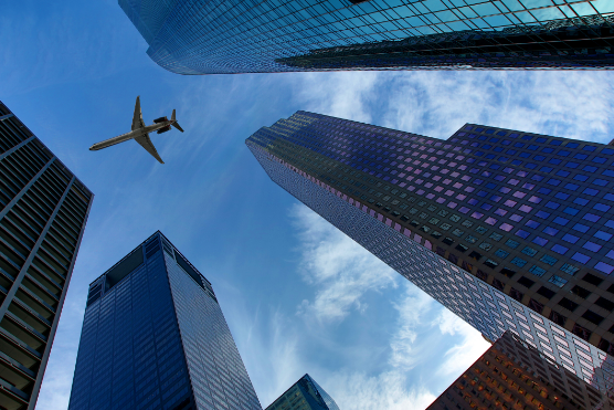 Airplane flying over downtown