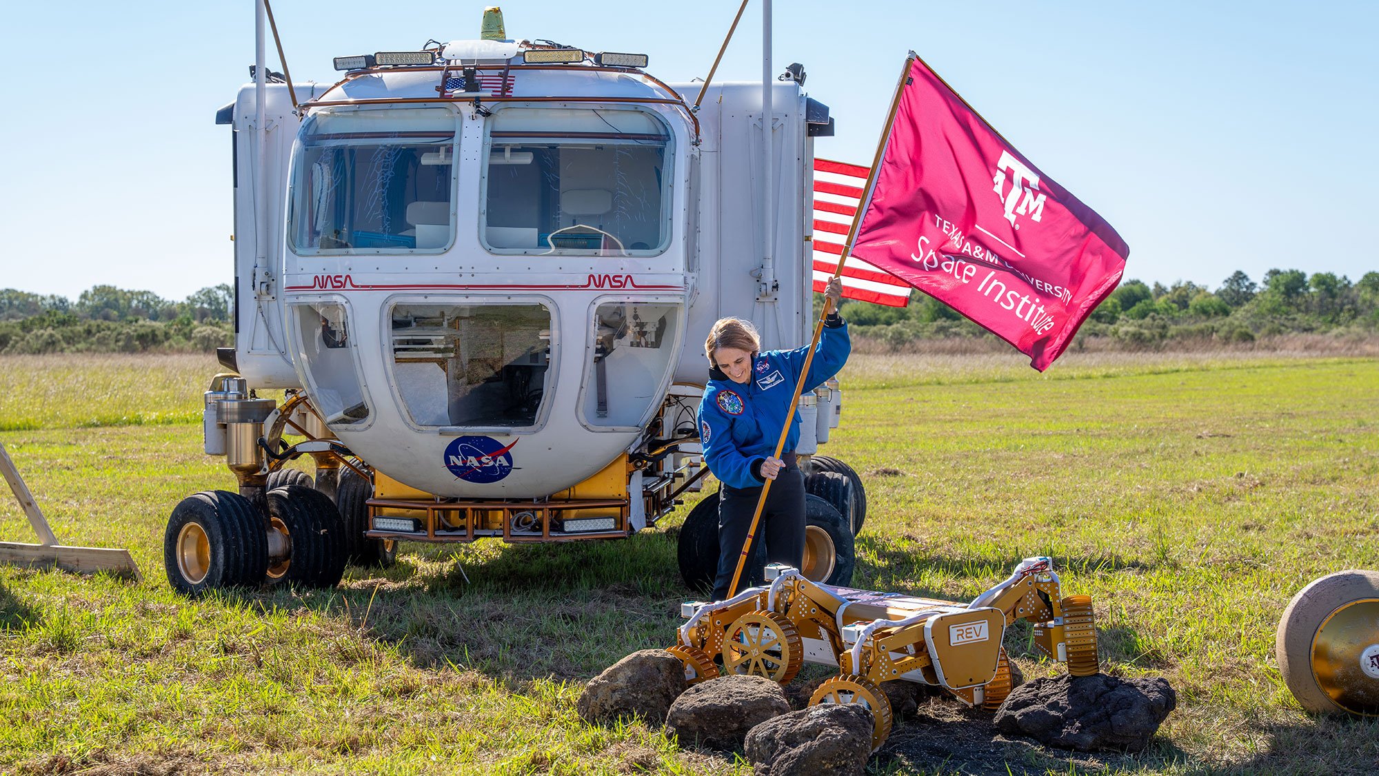 Texas A&M University Space Institute Director Dr. Nancy Currie-Gregg plants a flag for the new institute during a groundbreaking ceremony.